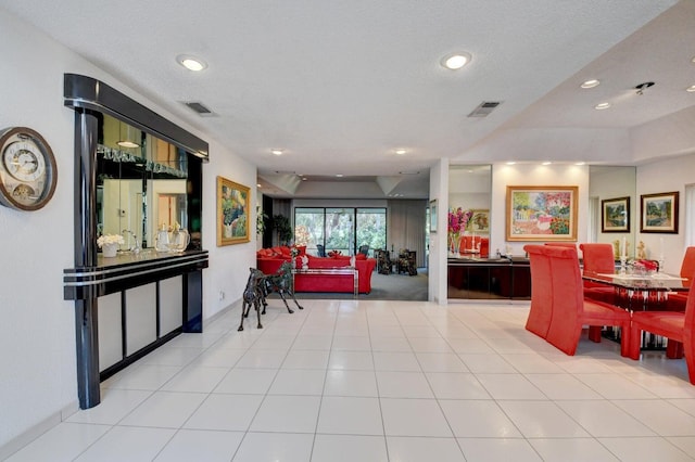 interior space with light tile patterned floors and a textured ceiling