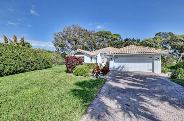 view of front of home with a front lawn and a garage