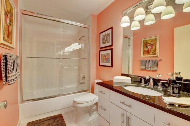 full bathroom featuring shower / bath combination with glass door, tile patterned floors, vanity, and toilet