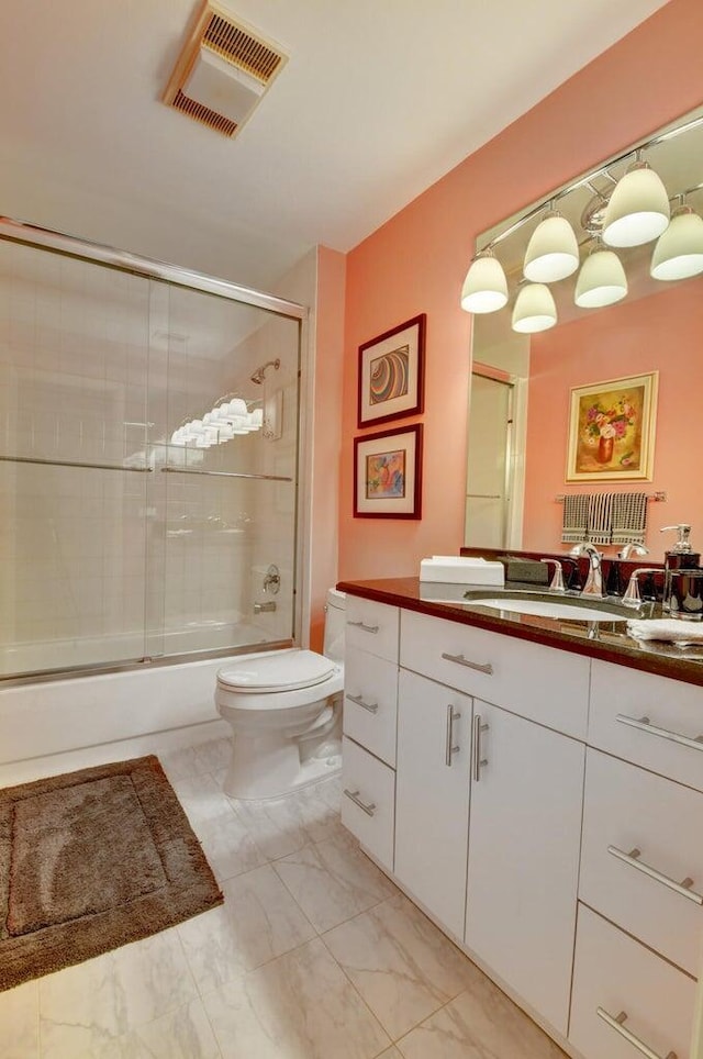 full bathroom with toilet, vanity, and combined bath / shower with glass door