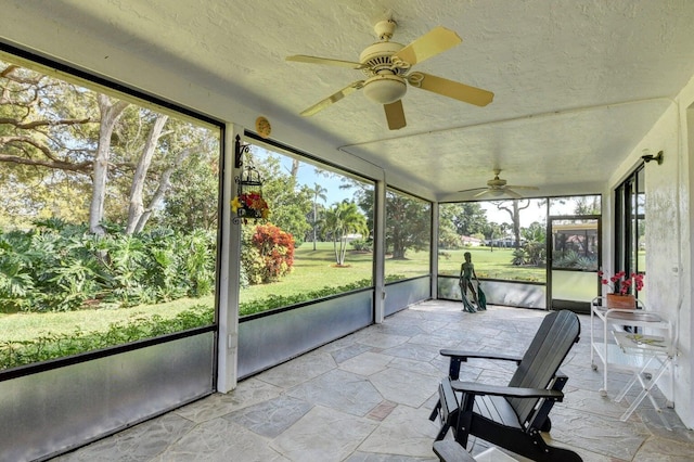 unfurnished sunroom with a wealth of natural light and ceiling fan