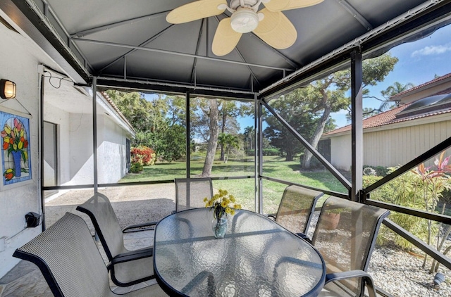 sunroom featuring ceiling fan and a healthy amount of sunlight