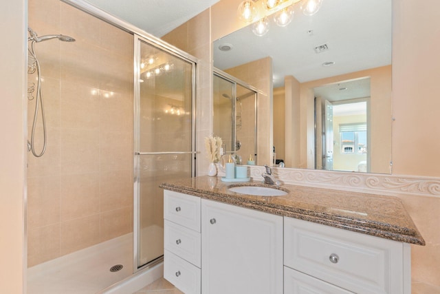 bathroom featuring an enclosed shower and vanity