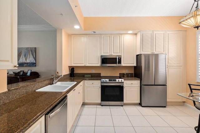 kitchen with appliances with stainless steel finishes, sink, light tile flooring, decorative light fixtures, and ornamental molding