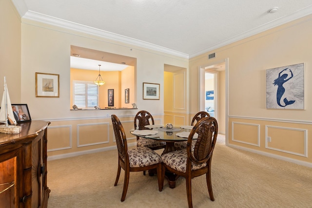 carpeted dining room featuring crown molding