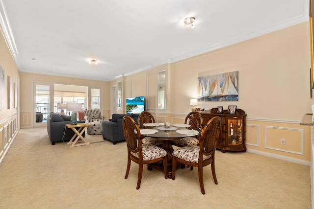 dining space featuring light colored carpet and crown molding