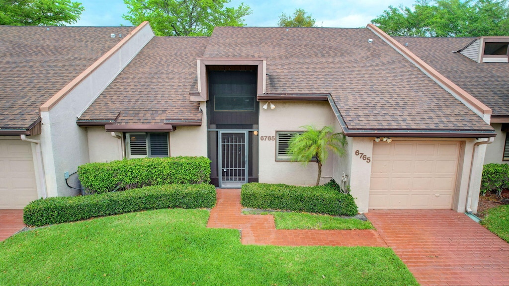 view of front facade with a front yard and a garage