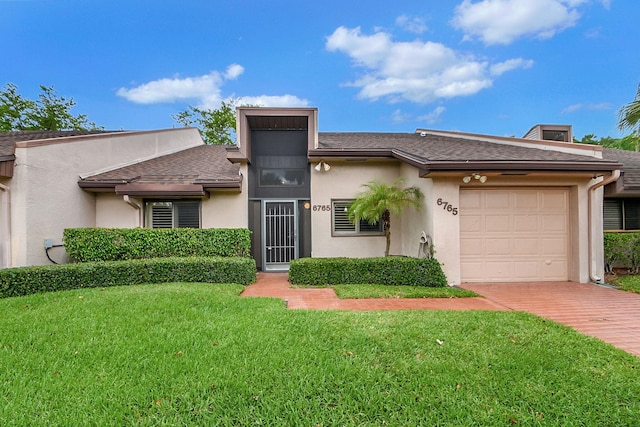 view of front of house with a front yard and a garage