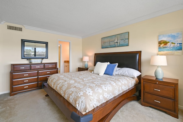 carpeted bedroom featuring a textured ceiling, ornamental molding, and ensuite bathroom