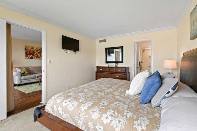 bedroom with a textured ceiling, crown molding, and light hardwood / wood-style flooring