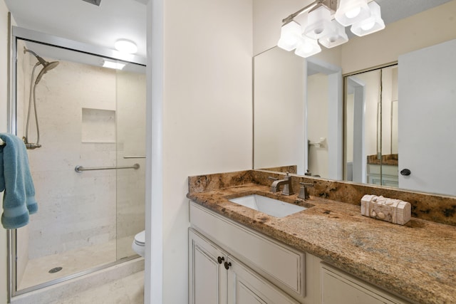 bathroom with oversized vanity, toilet, and walk in shower