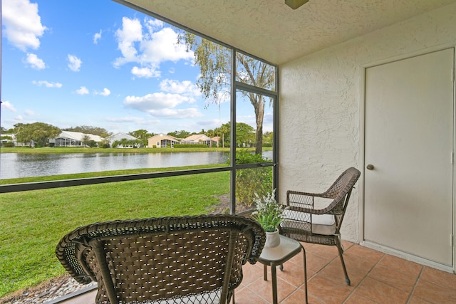 sunroom featuring a healthy amount of sunlight and a water view