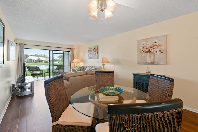 dining area with a textured ceiling, dark hardwood / wood-style floors, and ceiling fan