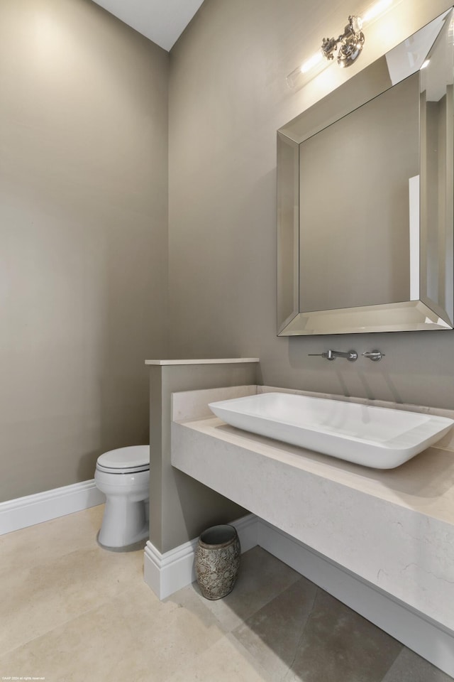 bathroom with tile patterned floors, vanity, and toilet