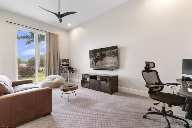 home office with light colored carpet, ceiling fan, and a healthy amount of sunlight