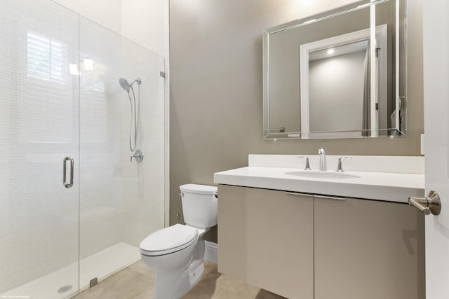 bathroom with vanity, toilet, and a shower with door