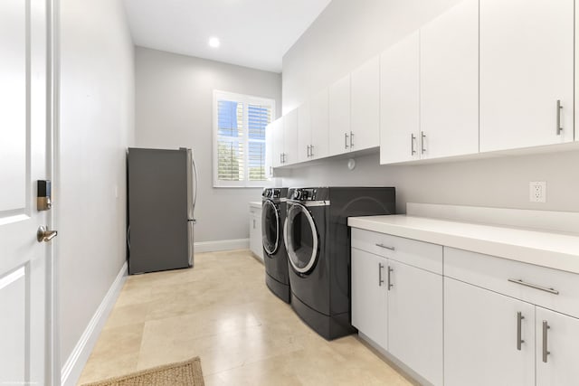 laundry area with cabinets and independent washer and dryer