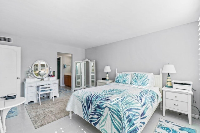 tiled bedroom featuring ensuite bathroom