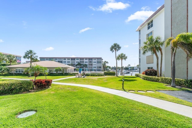 view of community featuring a yard and a water view