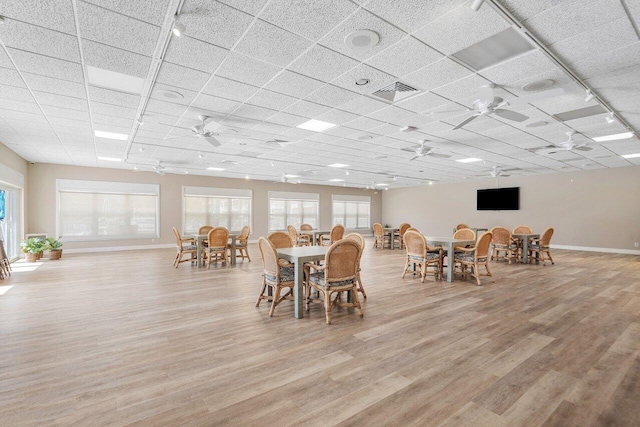 dining room featuring ceiling fan, a healthy amount of sunlight, and light hardwood / wood-style flooring