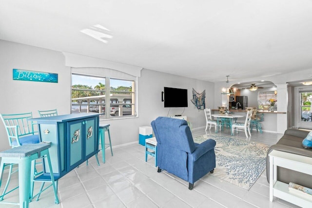 living room featuring light tile patterned floors and ceiling fan