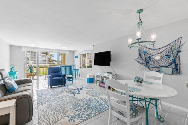 tiled living room with a notable chandelier