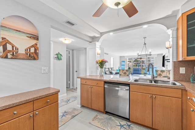 kitchen featuring ornate columns, backsplash, sink, light tile patterned floors, and stainless steel dishwasher