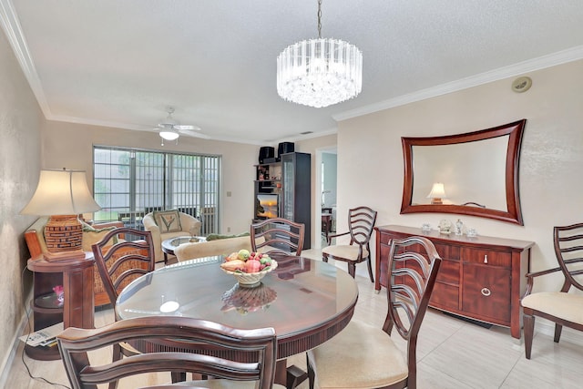 dining room featuring ceiling fan with notable chandelier, light tile floors, and ornamental molding