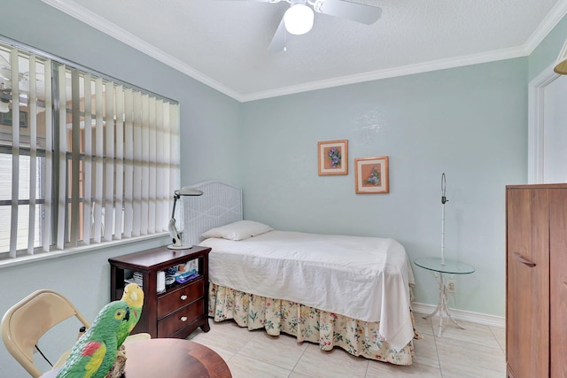 tiled bedroom with ornamental molding, ceiling fan, and a textured ceiling