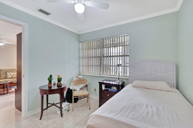 tiled bedroom with a textured ceiling, ceiling fan, and crown molding