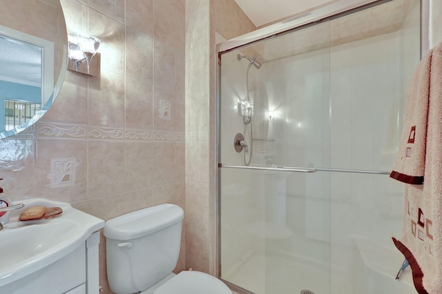 bathroom with tile walls, toilet, and large vanity