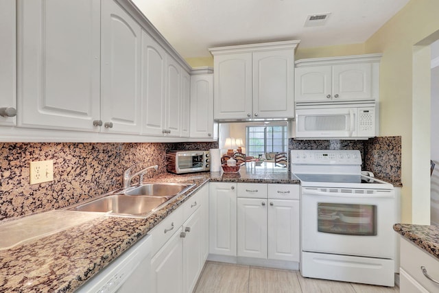 kitchen featuring white cabinets, sink, white appliances, and backsplash