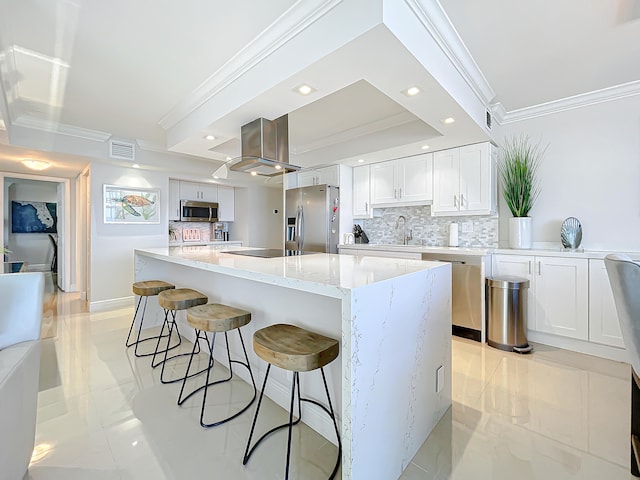 kitchen with appliances with stainless steel finishes, white cabinets, a center island, and light tile floors