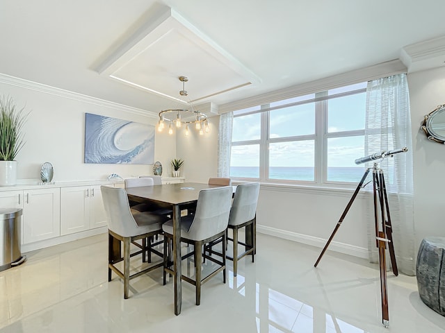 tiled dining space featuring a water view, a chandelier, and crown molding