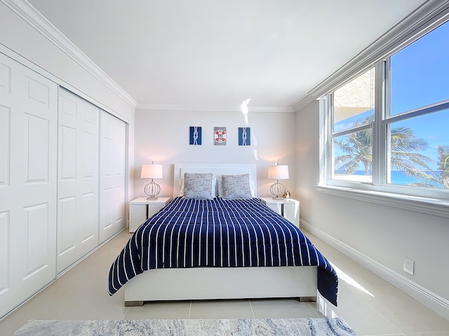 bedroom with a closet, light tile floors, and ornamental molding