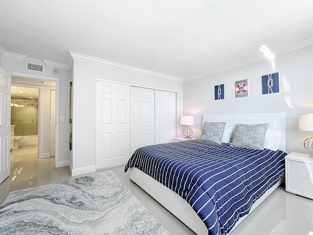 tiled bedroom with a closet and crown molding