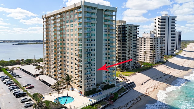 view of property featuring a water view and a pool