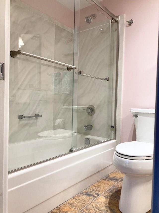 bathroom with enclosed tub / shower combo, toilet, and tile floors