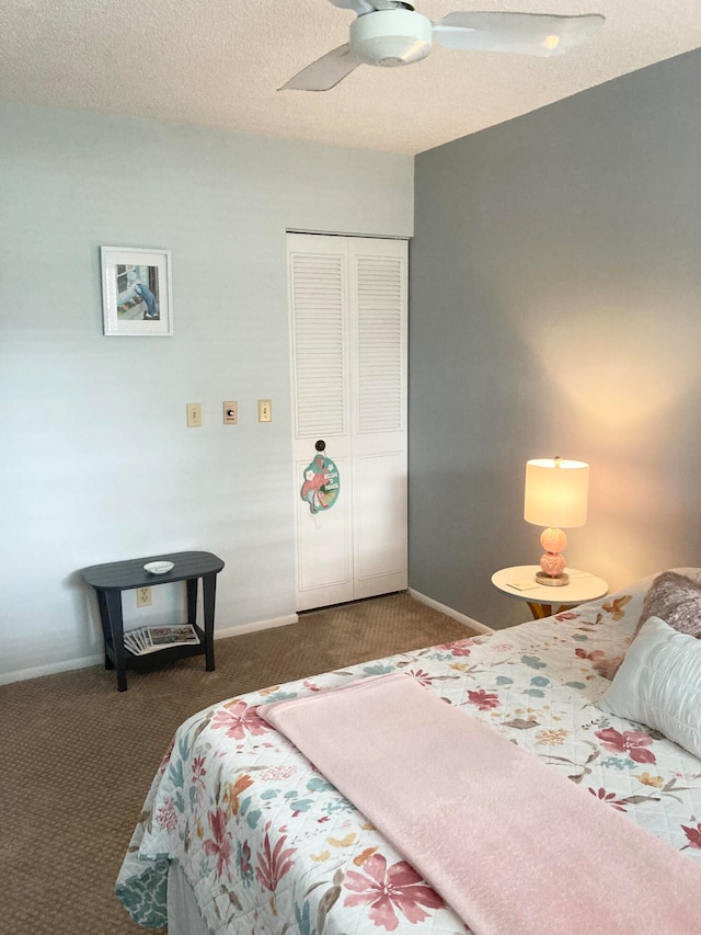 bedroom with a closet, ceiling fan, dark carpet, and a textured ceiling