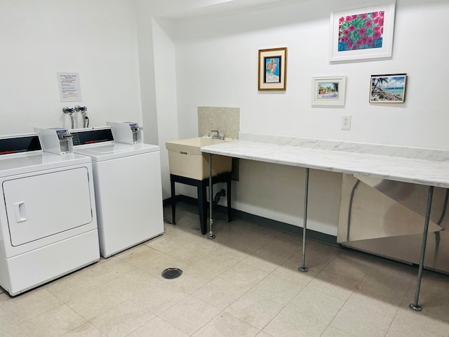 laundry room featuring hookup for a washing machine, washer and dryer, and light tile flooring