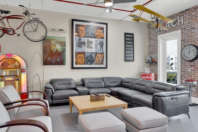 living room featuring concrete flooring and brick wall