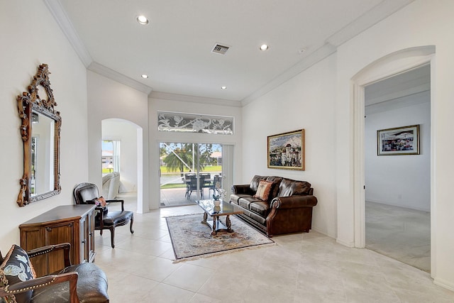 living room with crown molding and light tile floors