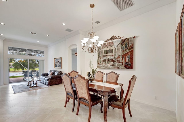 tiled dining room with a notable chandelier and ornamental molding