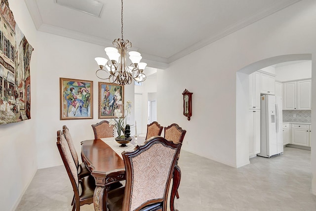 dining room with crown molding, a notable chandelier, and light tile flooring