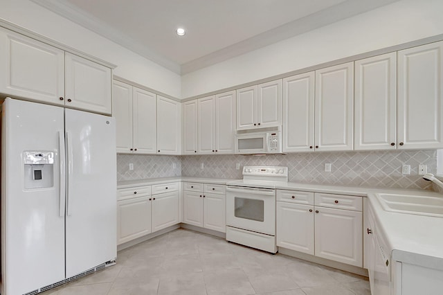 kitchen featuring white cabinets and white appliances