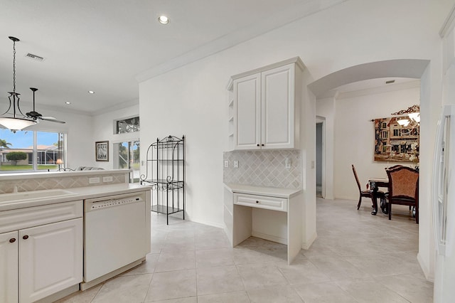 kitchen featuring light tile flooring, pendant lighting, tasteful backsplash, white dishwasher, and white cabinets