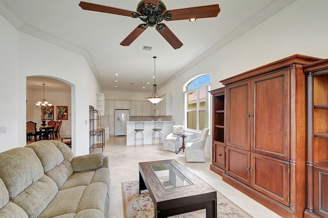 tiled living room featuring crown molding and ceiling fan with notable chandelier