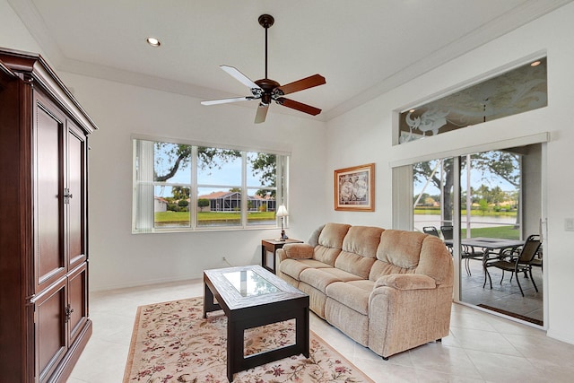 tiled living room featuring ceiling fan and crown molding