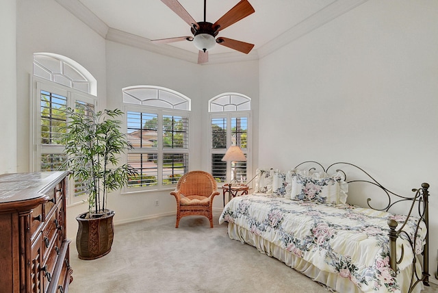 bedroom featuring ceiling fan, ornamental molding, light carpet, and a towering ceiling