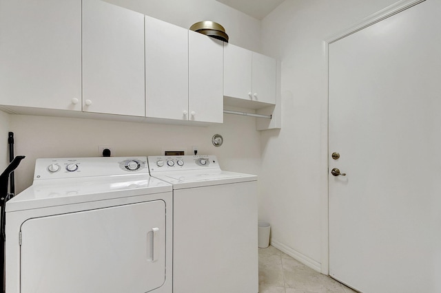 washroom with washing machine and dryer, cabinets, hookup for an electric dryer, and light tile floors